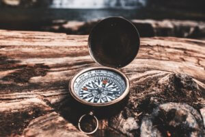 Brown compass on wood - finding yourself Ad Florem